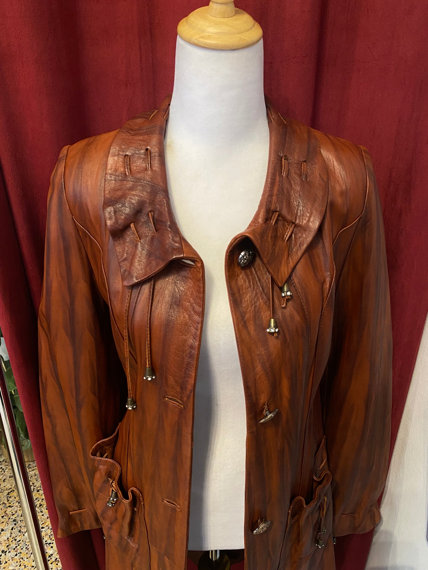 Elegant brown leather coat with intricate details 🥃