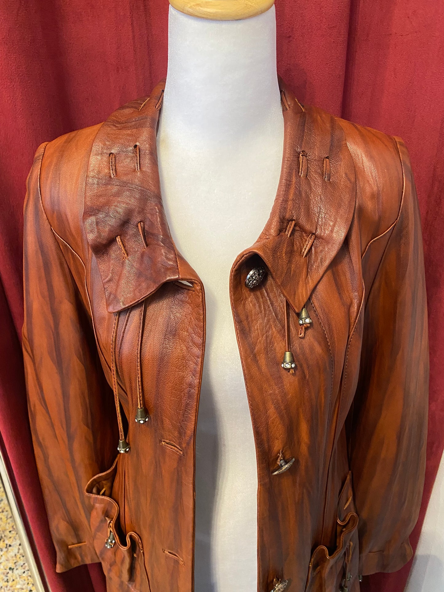 Elegant brown leather coat with intricate details 🥃