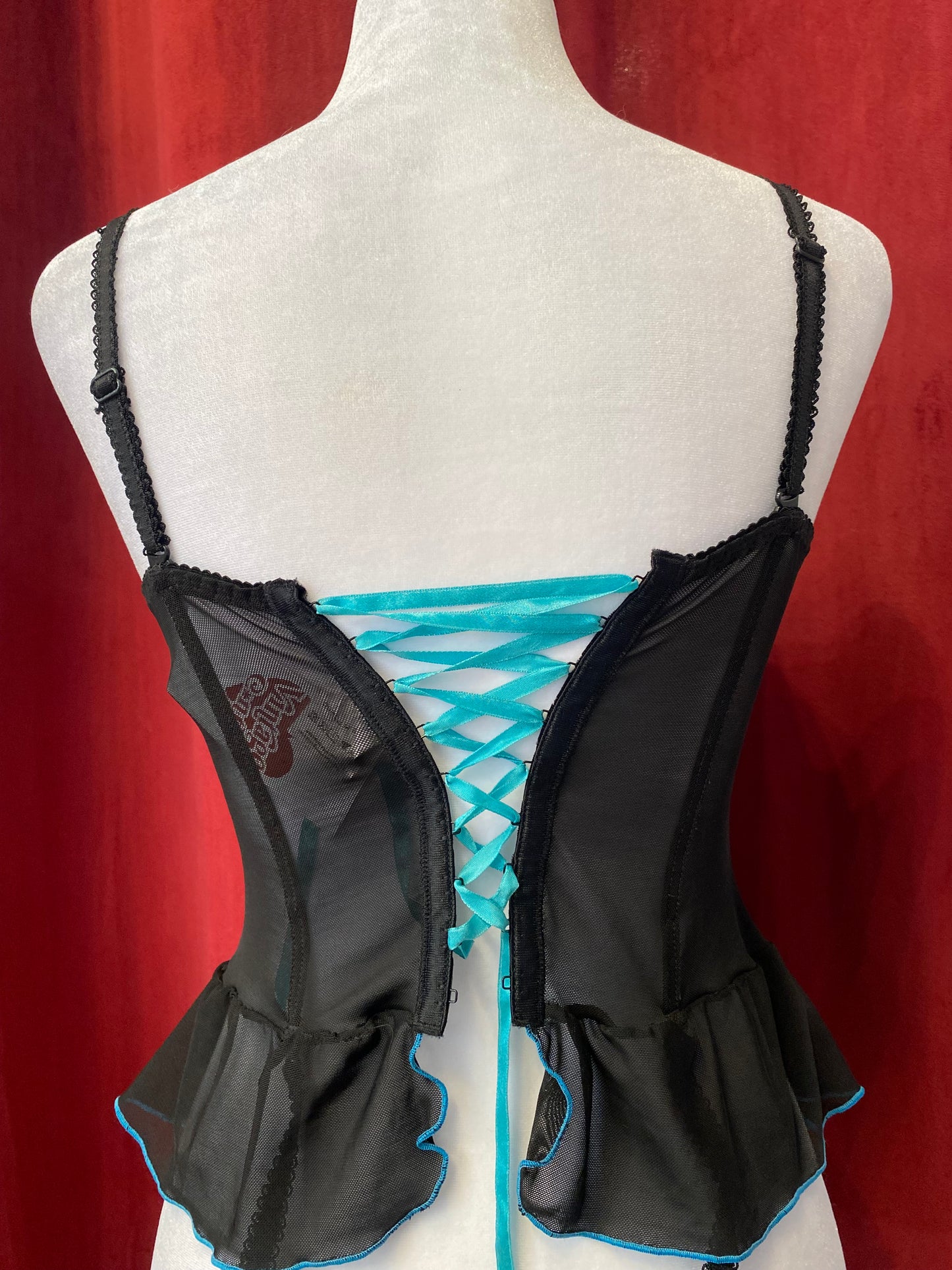 Black corset with blue hints and lace up details in the back