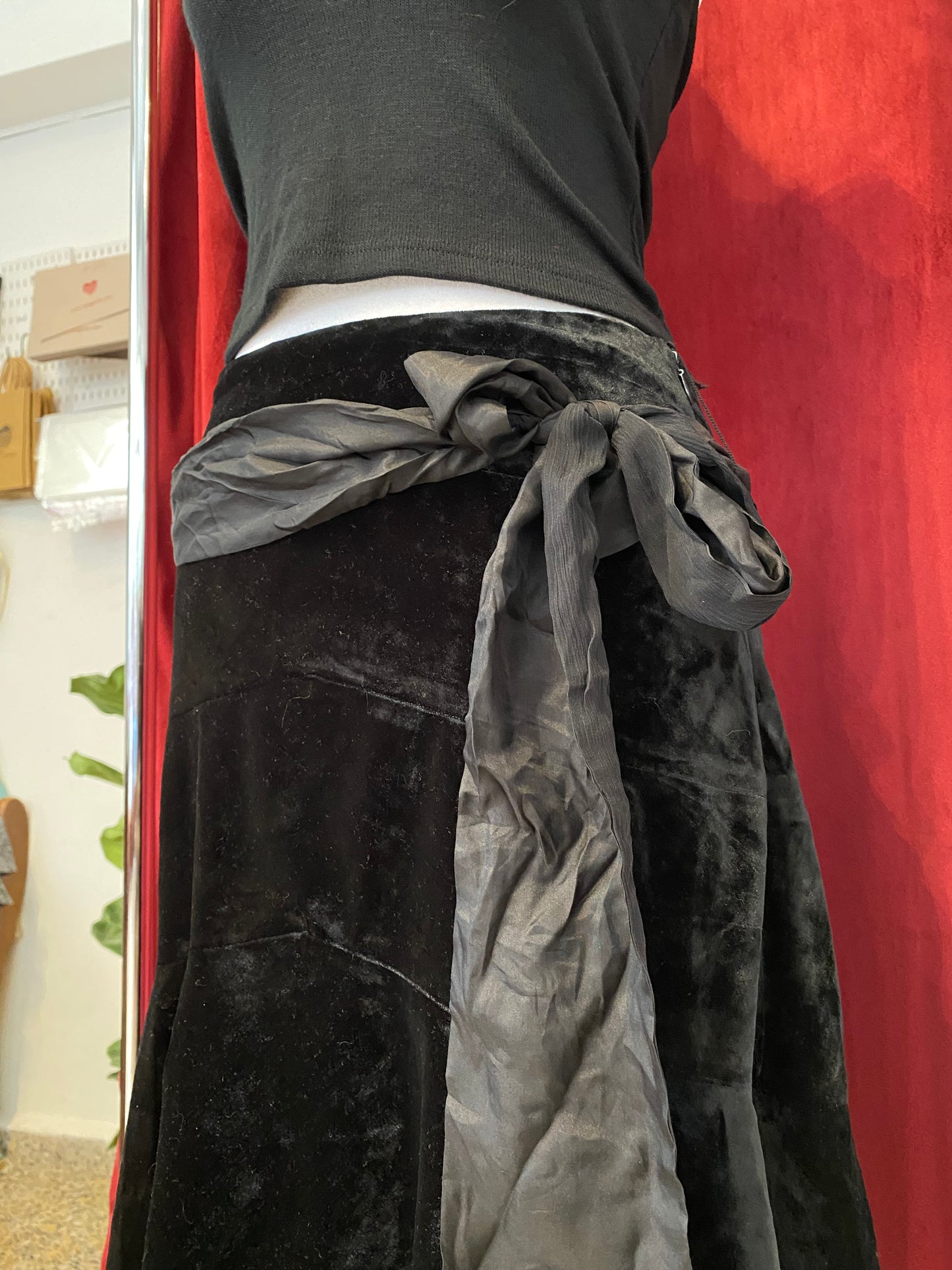 Black velvet midi skirt with complementary silk belt
