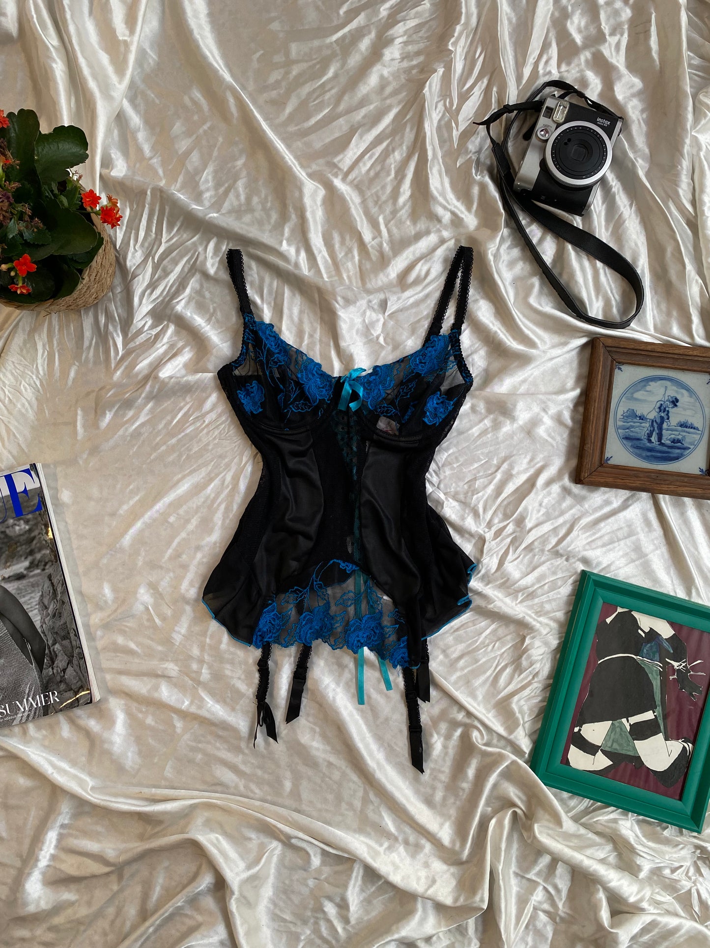 Black corset with blue hints and lace up details in the back