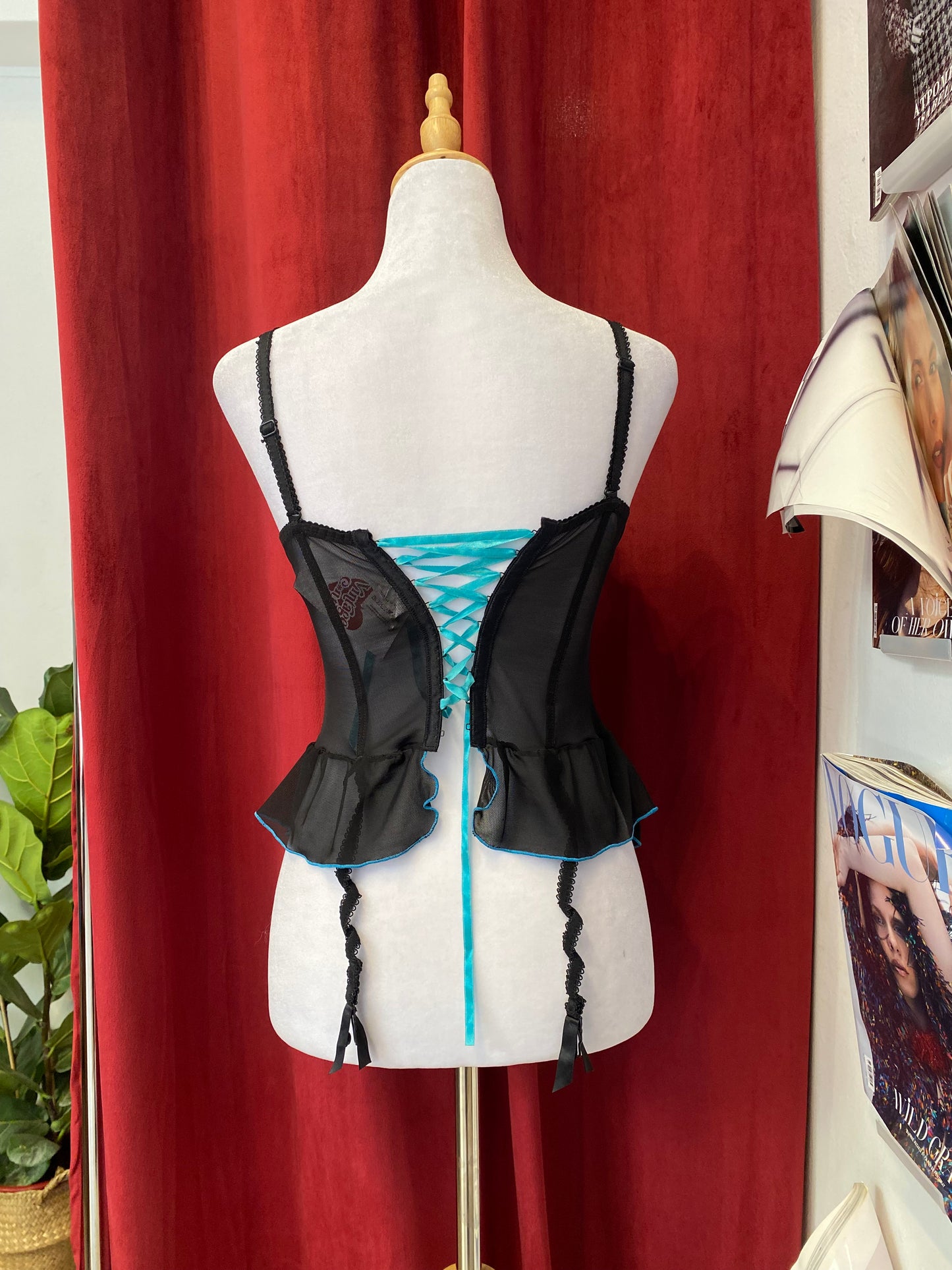 Black corset with blue hints and lace up details in the back
