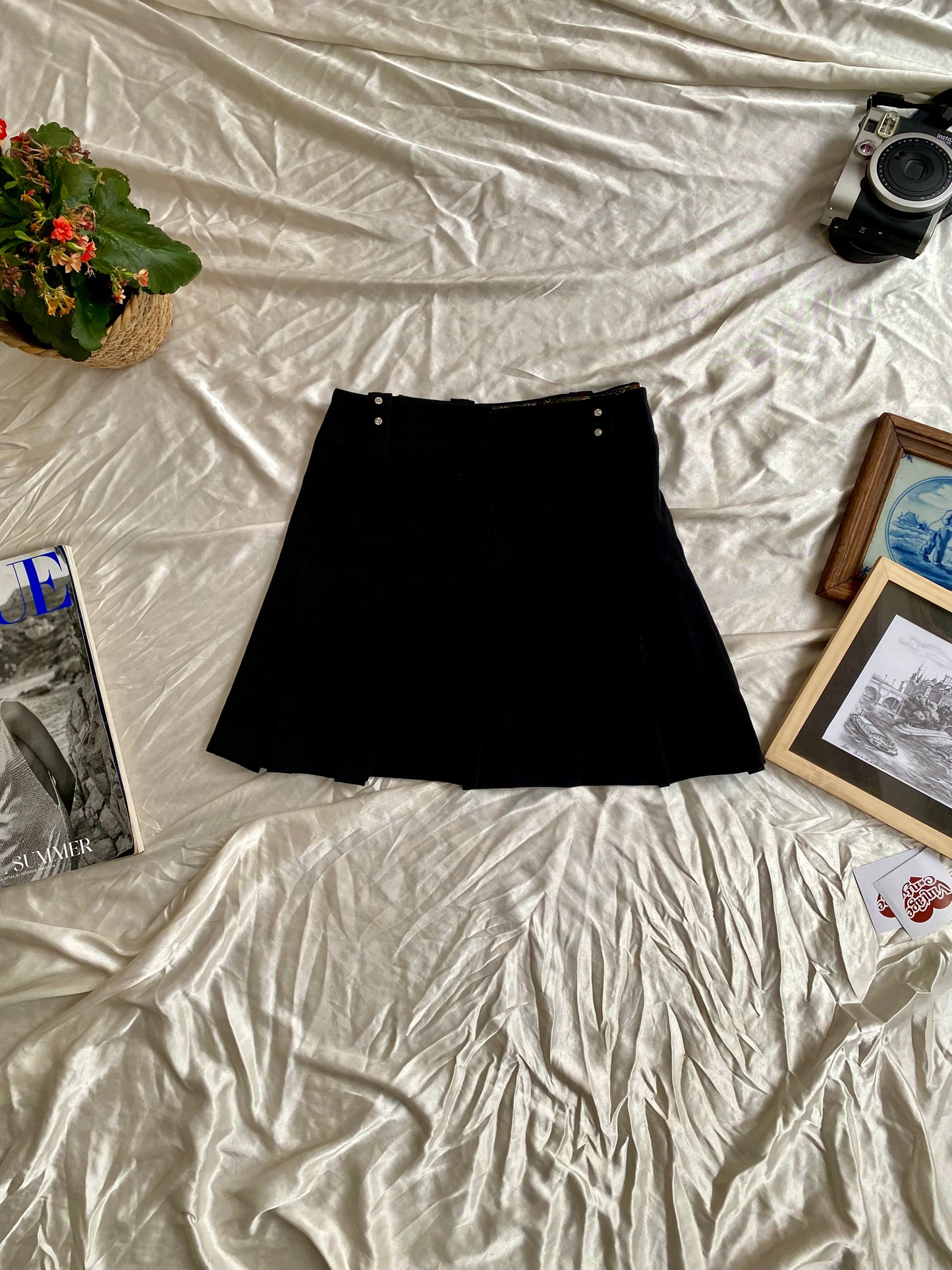 Mini black ruffled skirt with rhinestone details