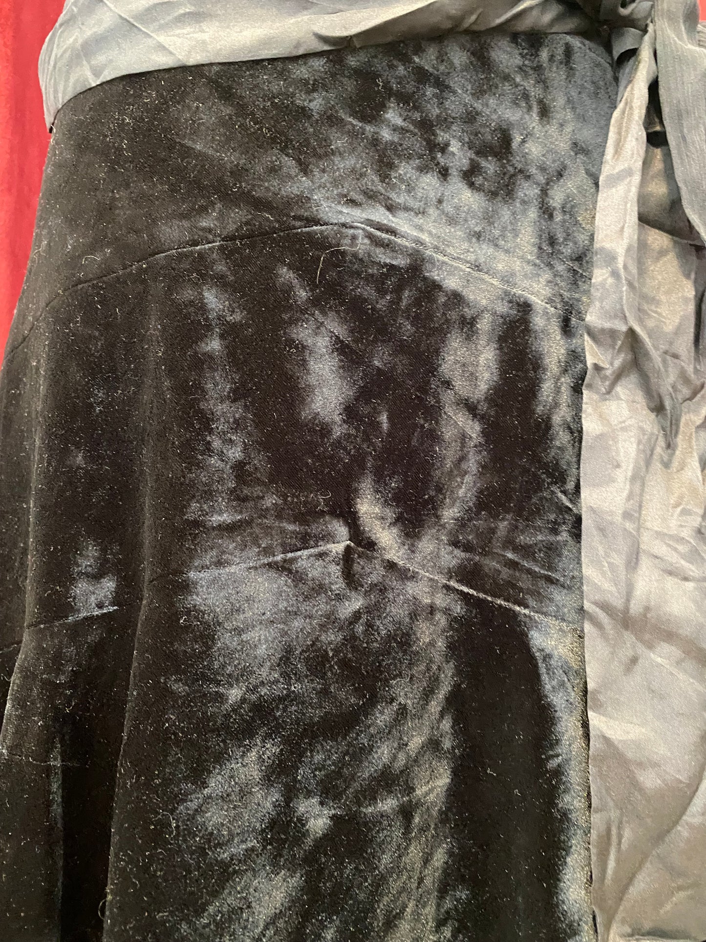 Black velvet midi skirt with complementary silk belt