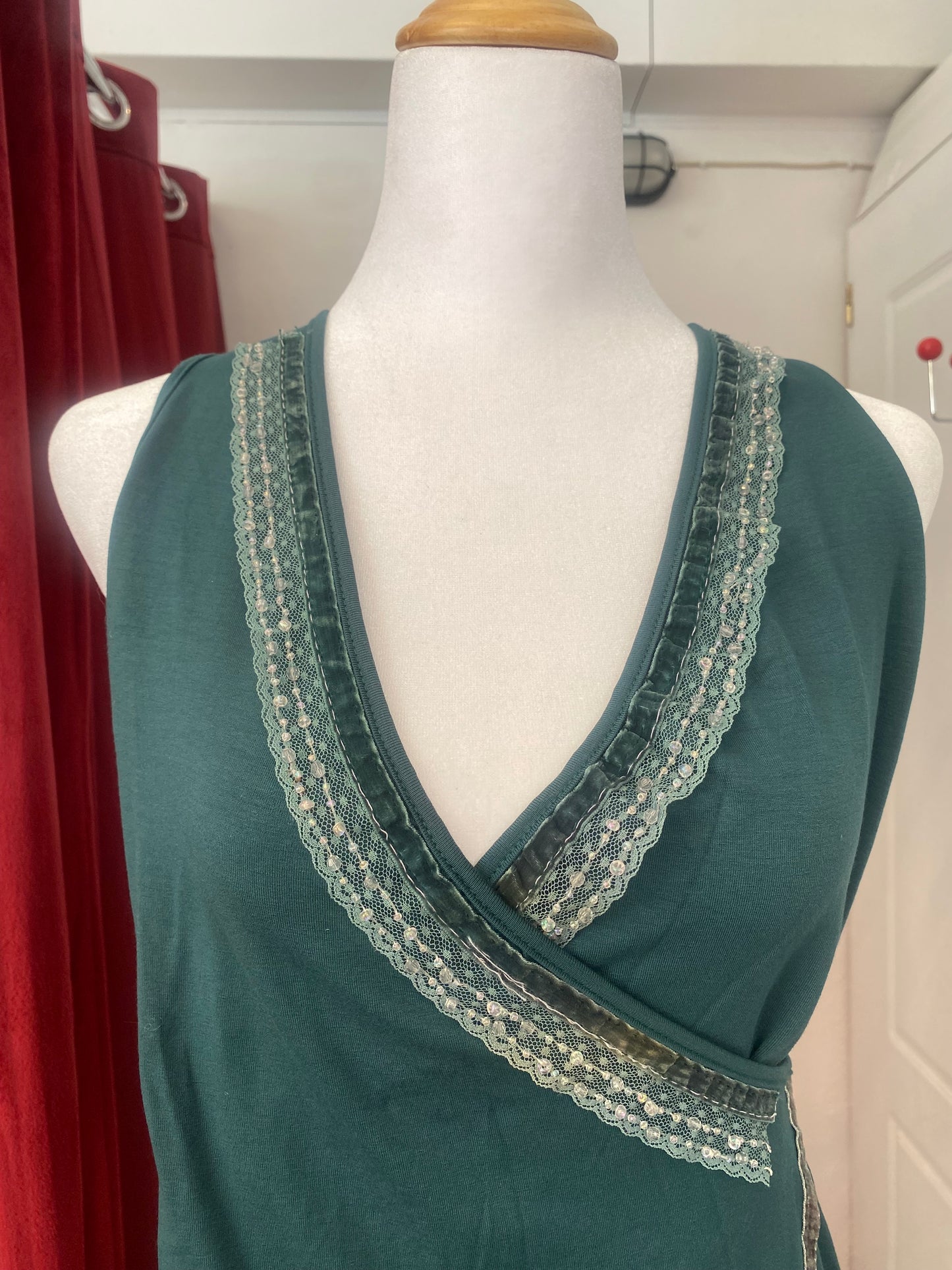 Brand new deep green top with sequin details