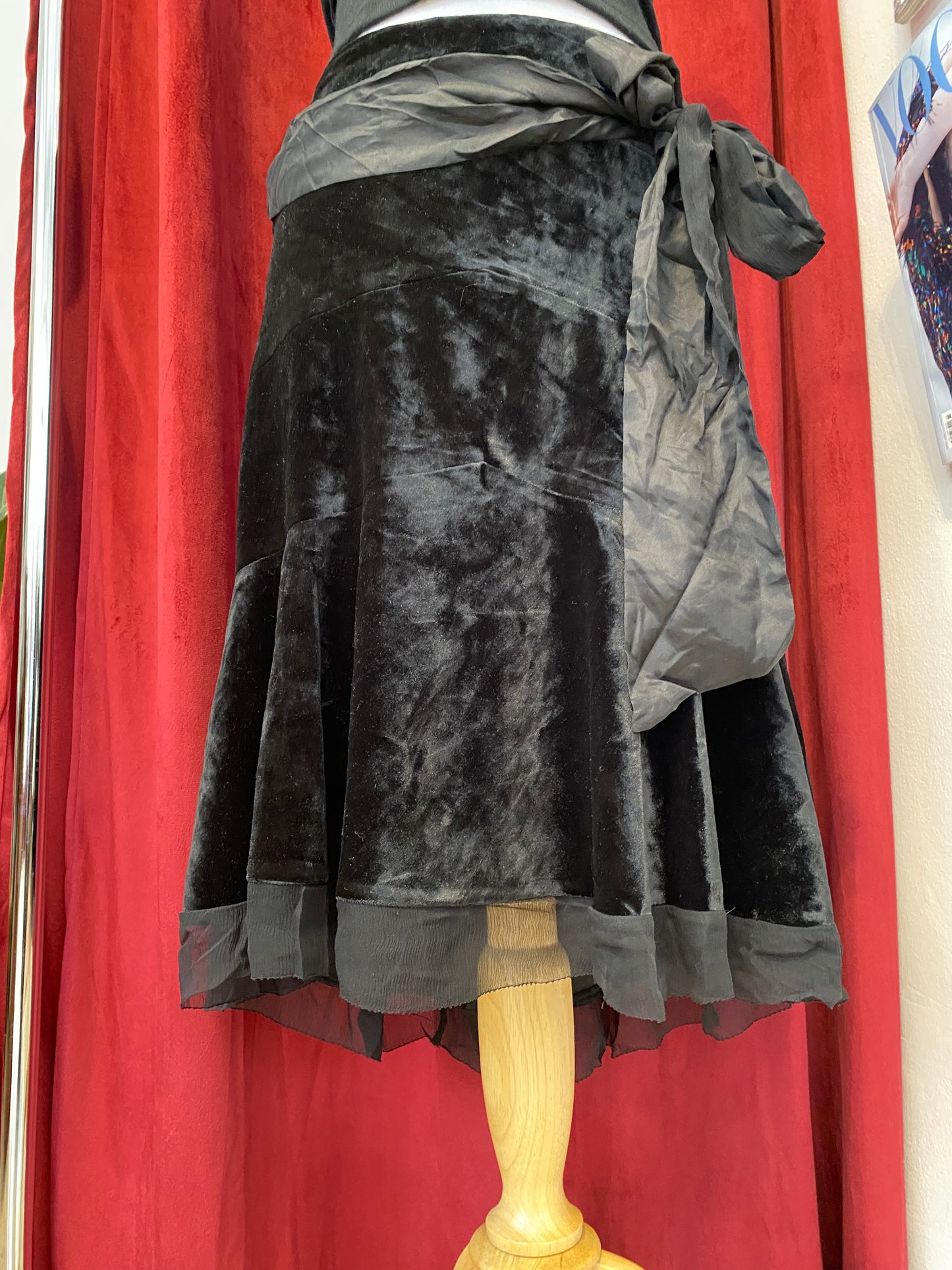 Black velvet midi skirt with complementary silk belt
